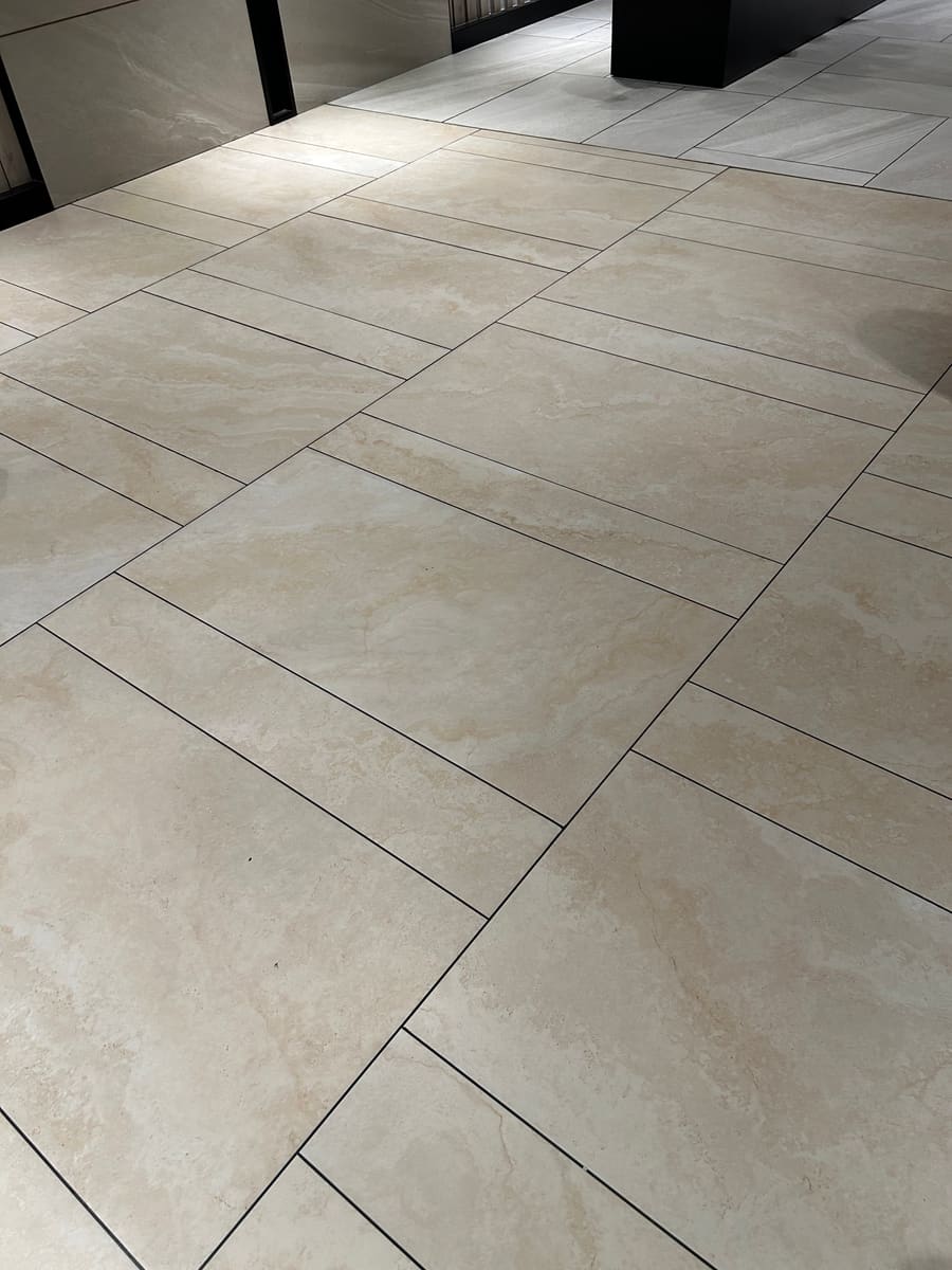 Large-format continuous porcelain floor in a delivered residential tower
